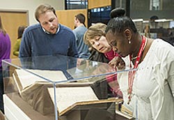 [photo, Research Archivist Tanner Sparks explaining rare documents on exhibit, Maryland Day Open House, State Archives, Annapolis, Maryland, March 2014]